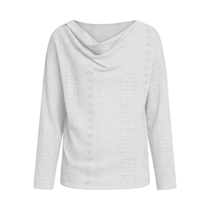 Close-up of white loose V-neck top featuring hollow out embroidery and cowl neckline detail