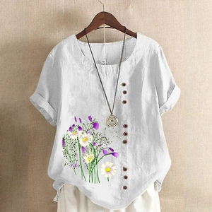 Detail of round neckline and floral print on white cotton linen short sleeve blouse
