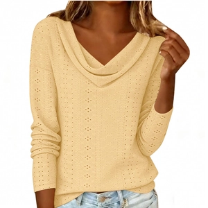 Close-up of beige long sleeve top featuring detailed eyelet hollow texture and draped V-neck