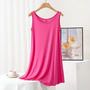 Detail view of rose pink modal dress on wooden hanger with soft fabric texture