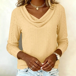 Close-up of beige eyelet crochet fabric texture on long sleeve cowl neck top for women