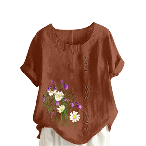 Close-up of retro brown buttons and white daisy print on a brick red linen shirt