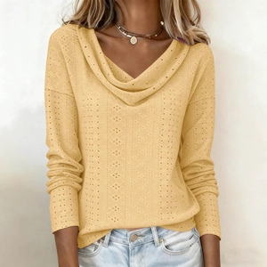 Detailed view of the yellow hollow-out knit fabric and draped cowl neck collar