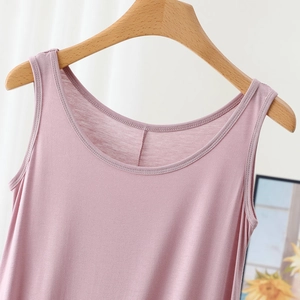 Close-up of the scoop neckline and shoulder straps of a soft mauve modal tank dress