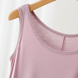 Detail of round neck and wide shoulder straps on a soft modal dress in dusty rose
