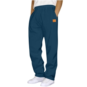 Detail of navy joggers showing elastic drawstring waistband and orange patch