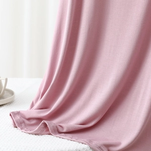 Detailed shot of soft pink modal fabric showing quality stitching and drape texture