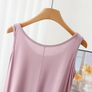 Close-up of mauve modal sleeveless dress neck detail on a wooden hanger with sunflower art