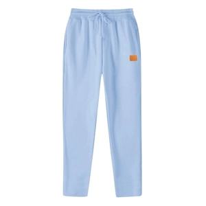 Detail of light blue casual trousers showing elastic drawstring waist and orange patch