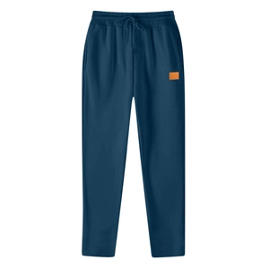 Detail of navy blue sports sweatpants with elastic waist, drawstring, and orange patch