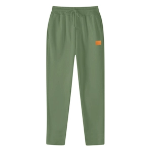 Detail of olive green joggers showing elastic drawstring waistband and orange woven label