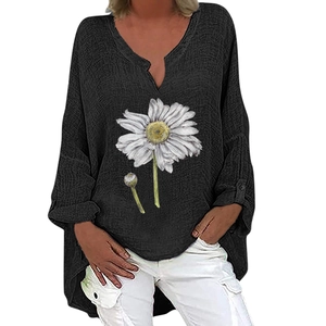 Detail view of black V-neck cotton linen top featuring a white daisy floral print