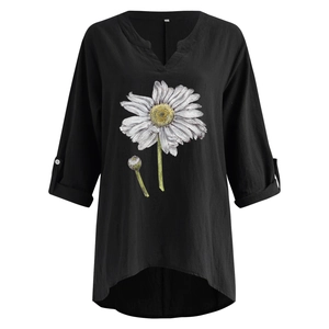 Detail of floral printed black V-neck linen top with roll-tab sleeves and daisy pattern