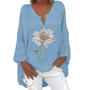 Detail of blue cotton linen top with white daisy print and adjustable tab sleeves