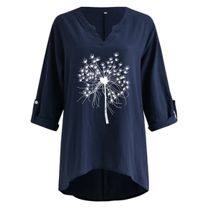 Close-up of V-neckline and white dandelion print on dark blue cotton linen blouse