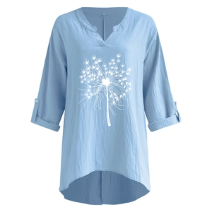 Detail of light blue cotton linen blouse with V-neck and white dandelion print