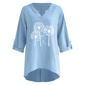 Detail of light blue linen shirt with dandelion print, V-neck, and roll-tab long sleeves