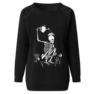 Close-up detail of white screen-printed skeleton watering plants on black sweatshirt