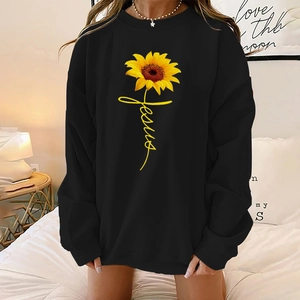 Detail of sunflower and Jesus print on a black oversized drop shoulder sweatshirt