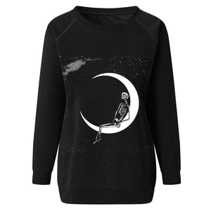 Close-up of skeleton on crescent moon graphic print on a black long-sleeved sweatshirt