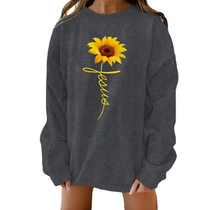 Detail of yellow sunflower print and Jesus script on dark grey oversized sweatshirt