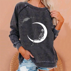 Close-up of Halloween skull and moon print on charcoal grey oversized crewneck sweatshirt