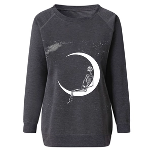 Detailed view of white skull sitting on a moon print on dark gray sweatshirt