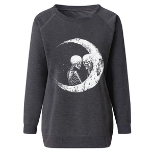 Detail of skull and crescent moon print on charcoal grey oversized sweatshirt fabric