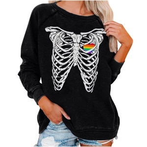 Detail of a black sweatshirt featuring white skeleton ribs and a rainbow heart print