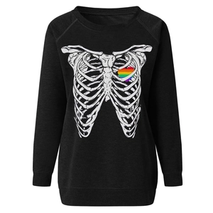 Close-up of skeleton rib print and rainbow heart detail on black crewneck sweatshirt
