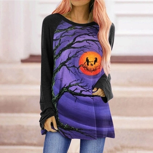 Detail of raglan sleeves and Halloween print with purple forest and orange moon