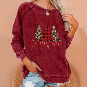 Close-up of Merry Christmas lettering and leopard print tree design on burgundy sweatshirt