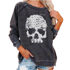 Close-up of artistic white skull and crow print on a dark grey washed sweatshirt