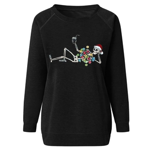 Close-up of black Christmas sweatshirt with festive skeleton print and ribbed cuffs