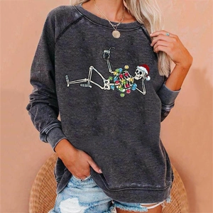 Close-up of skeleton with Christmas hat and colorful lights print on a grey sweatshirt