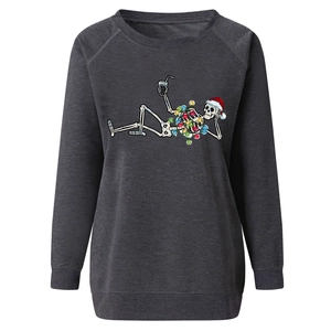 Detail of a charcoal grey Christmas sweatshirt with a skeleton wearing a festive red hat