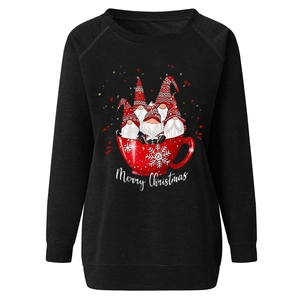 Close-up of black Christmas sweatshirt with gnomes in a mug and Merry Christmas text