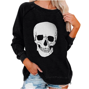 Close-up of loose-fit black sweatshirt featuring a realistic skull print on the front