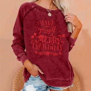 Close-up of Christmas themed prints and soft fabric detail on this burgundy sweatshirt