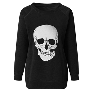 Close-up of the detailed white skull print on a black long-sleeve crewneck sweatshirt