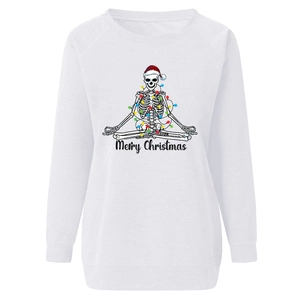 Close-up of festive skull print with Christmas lights on a white long-sleeve sweatshirt