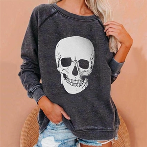 Detail of grey crewneck sweatshirt with white skull print and vintage distressed texture
