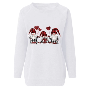 Close-up of three festive gnomes with buffalo plaid hats on a white crewneck sweatshirt