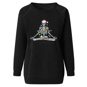 Detail of a black sweatshirt with a yoga skeleton in a Santa hat and Merry Christmas text