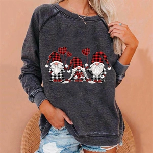 Detail of loose Christmas sweatshirt with three gnomes and red plaid heart patterns