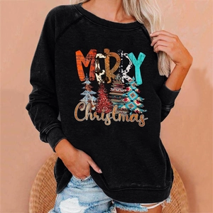 Detail of the boho Merry Christmas print and festive tree graphics on a black sweatshirt