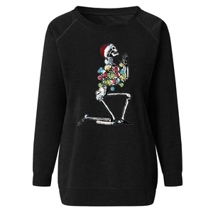 Detail of a Christmas skeleton print with festive lights on a black sweatshirt