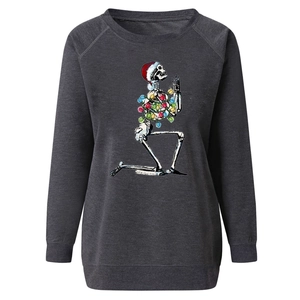 Detail of Christmas skeleton print and raglan sleeve on dark grey heather sweatshirt