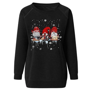 Detail of Christmas gnomes and sewing machine print on a black crewneck sweatshirt