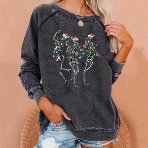 Detail of Christmas skeleton print on dark grey sweatshirt worn by a model in casual setting